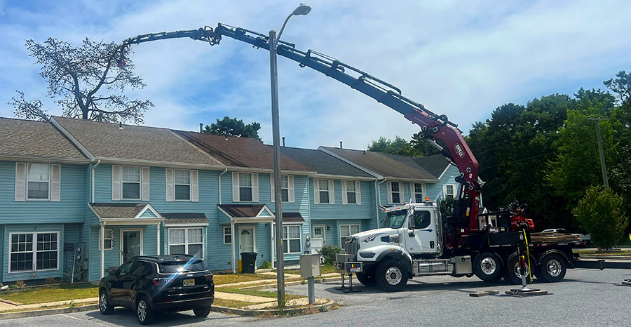 Image showing the JMA Tree Crane reaching over a house to dismantle a tree