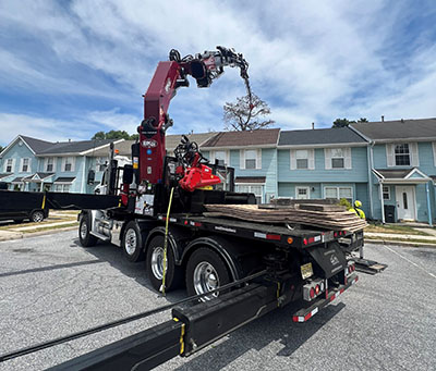 Picture showing JMA Tree Removal Crane reaching over house roof