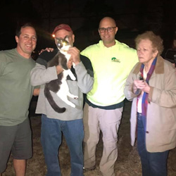 Picture of JMA staff helping the community rescue a cat